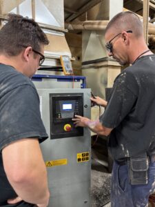Service technician training with customer on an air compressor.